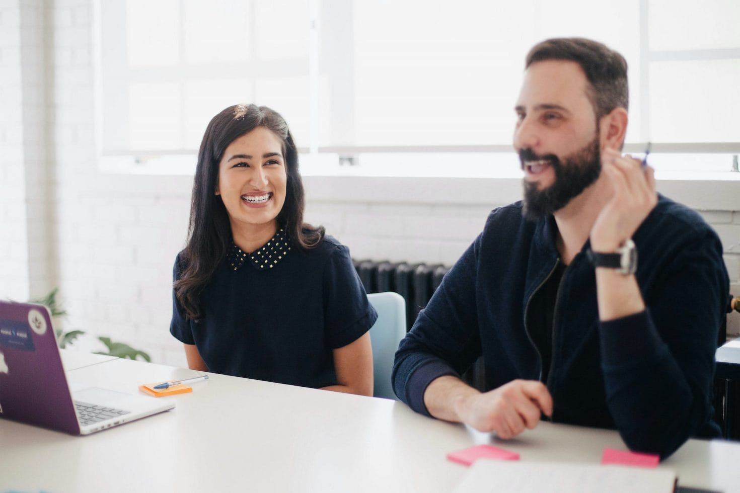 Two people talking at team meeting