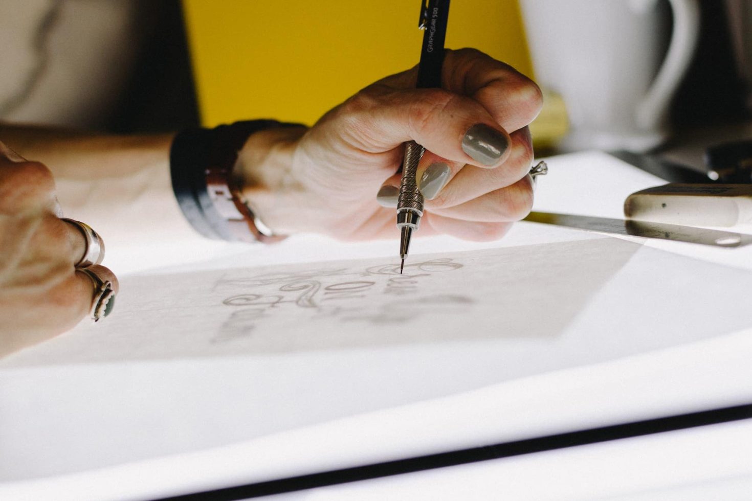 Person sketching typography